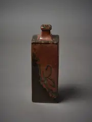 A square sided bottle vase by Len Castle, in tenmoku glaze with wax resist decoration, sold Mar 2023