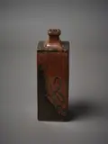 Len Castle, A square sided bottle vase, in tenmoku glaze with wax resist decoration