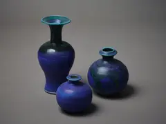 Three vases by Graeme Storm, one larger and trumpet shaped (230 x 110 x 110mm) and two smaller wheel thrown vases (150 x 120 x 120mm and 110 x 100mm), sold Mar 2023