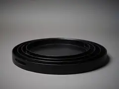 A set of four Italian black timber trays by Villa Milano, sold Mar 2023