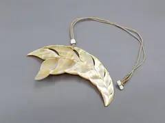 Steve Myhre, Leaf-shaped mother-of-pearl pendant, carved & polished mother-of-pearl pendant decorated with dolphin's flukes, cord necklace