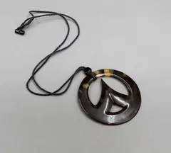 Steve Myhre, Small faux turtle shell pendant, faux turtle shell pendant of round shape with pinnacle form in its centre, cord necklace