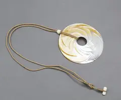 Steve Myhre, Round mother-of-pearl pendant, carved & polished mother-of-pearl pendant on cord necklace