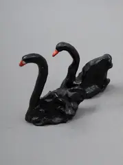 Two Black Swans by Martin Poppelwell, glazed earthenware, two parts, sold Nov 2022