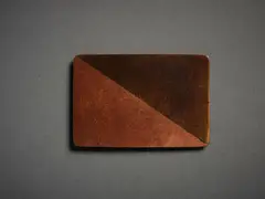 Untitled, Badge by John Edgar, copper and bronze, shaped and patinated, sold Sep 2022