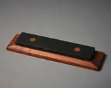 John Edgar, Grindstone, granite with copper inserts on wooden stand, 1992