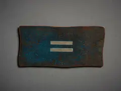 Untitled, Badge by John Edgar, mixed metal, shaped and patinated, sold Sep 2022