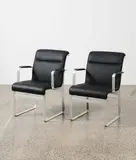 Pair of 1970s armchairs by Sweden Karl Erik Ekselius for J O Carlsson, aluminium and black vinyl, sold Jun 2022