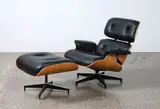Charles and Ray Eames, A ‘670’ and ‘671’ lounge chair and matching ottoman, in black leather upholstery and walnut veneer, originally designed in 1956, this example manufactured under licence by Herman Miller in 2009