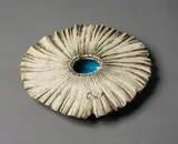 Large Sea Secret by Len Castle, sculptured with a round jagged flat surface with dark umber pigment rubbed to the recesses, a pool of alkaline glaze to , sold Jun 2022