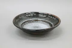 Stoneware deep dish by Len Castle, with detailed rim, grey and tenmoku glazes, sold Jun 2022
