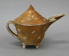 Jeff Oestreicht, Sculptural teapot, wood fired salt glazed stoneware, with carved geometrical decoration on reserve, c. 1992