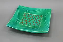 Merilyn Wiseman, Large square ceramic platter, in bright green glaze with abstract orange decoration to the centre and to the underside