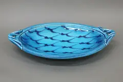 Merilyn Wiseman, Large oval ceramic platter, in bright blue glaze, painted in darker blue with a net pattern to the well