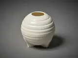 Ribbed vase by Crown Lynn Potteries, of spherical form on a tripod base, sold Jun 2022