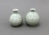 Two matching pale celadon vases by Len Castle, porcelain with thinly crackled glaze, decorated with a combed wavy design, sold Jun 2022