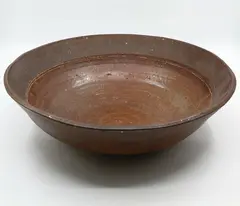 Large stoneware bowl by Warren Tippett, rich burnt sienna hue, sold Jun 2022