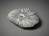 Large Sea Secret by Len Castle, sculptured with a round jagged flat surface with dark umber pigment and black paint, a pool of alkaline glaze to the int, sold Jun 2022