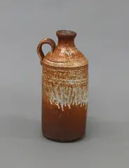 Shino glazed bottle by Len Castle, stoneware, with cylinder body and a short looping handle to the shoulder, sold Jun 2022