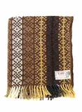 Onehunga Woollen Mills, Te Ariki travel rug, with a tukutuku panel pattern in mustard yellow, light and dark browns, black, white and with a fine green line woven throughout