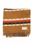 Onehunga Woollen Mills, Te Ariki travel rug, with a tukutuku panel pattern in light brown, red, white, and black