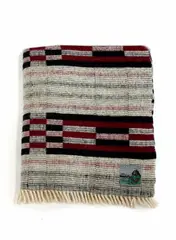 Early Manatunga travel rug by Roslyn Dunedin textiles, with a tukutuku panel pattern in white, magenta, and black, sold Jun 2022