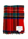 ‘Sylvia’ travel rug by Onehunga Woollen Mills Ltd for L.D. Nathan (Wholesale) Ltd, with a ‘Royal Stewart’ tartan pattern in red, green, blue, black, and fine white and yellow, sold Jun 2022