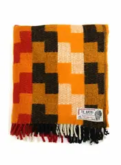 Onehunga Woollen Mills, Te Ariki travel rug, with a poutama (stairway to heaven) tukutuku panel design in orange, red, black and white
