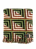 Mosgiel Woollens Ltd, Manatunga travel rug, decorated with a tukutuku panel pattern in olive green, brown, black and white