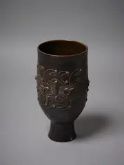 Large vase by Edwin and Mary Scheier, c.1960s, glazed earthenware vase of cylindrical shape supported by a tall foot, with mahogany iridescent surface decorat, sold Nov 2021