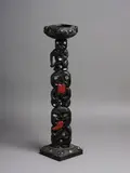 Carving by New Zealand Folk Art, on a Māori theme consisting of a column of three gesturing figures in black, raised over a square pedestal base and moun, sold Nov 2021