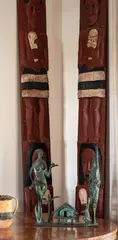 Ngāpuhi tribal region, An impressive pair of Amo boards, carved with male and female warrior figures wearing piupiu. The female figures each holding a patu and the male figures holding kotiate and wahaika. Circa 1920.
