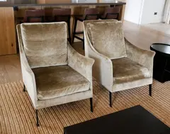 Flexform, A pair of Boss armchairs, with down filled cushion and backrest and black chromed metal feet, made in Italy