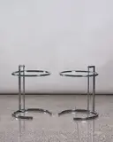 Eileen Grey, Pair of E1027 adjustable side tables, made by ClassiCon and authorised by Aram Design, chrome tubular steel framing with glass circular top