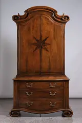 Thieren Studio Workshops, Walnut two door cabinet, over three drawers with inlaid starburst decoration and scroll feet