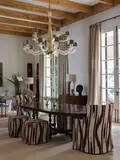Usa Dennis and Leen, A reproduction Spanish oval dining table, in dark walnut, with two removeable centre leaves on stretchered base with turned legs