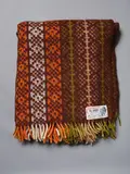 Te Ariki, Travel rug, with a tukutuku panel design in green, brown, orange and white