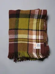 Travel Rug by Kaiapoi Huia, in a green, brown, black and white tartan design, sold Dec 2020