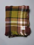 Kaiapoi Huia, Travel Rug, in a green, brown, black and white tartan design