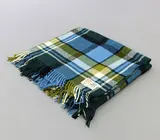 Kaiapoi Huia, Travel Rug, in a turquoise, green, olive, black and white tartan design