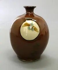 Mashiko Pottery, Globular bottle vase, stoneware, decorated with wax-resist medallions with gestural decoration over a rich kaki glaze
