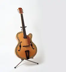 Michael Parekōwhai, Tua Rima from Patriot: Ten Guitars, flame maple, spruce, rewarewa, swamp kauri, ebony, paua shell and stand (1999)
