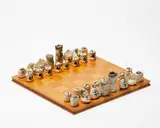 Bronwynne Cornish, Chess set, thirty-two hand-built ceramic figures with painted details, on a matched wooden chess board