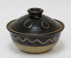 Lidded casserole dish by Barry Brickell, stoneware, wax resist abstract decoration on tenmoku glaze, sold Sep 2019
