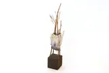 Debbie Pointon, Raku fired and bamboo twigs teapot sculptural form, on a wooden plinth
