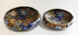 Frederick Rhead, Two Bursley Ware Amstel platters, painted ceramic with bird decoration