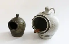 Neil Grant, Stoneware salt pig, with wooden spoon, together with a smaller one by unknown potter
