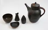 Pat Perrin, Stoneware coffee set, including a coffee pot, a cup and a milk jug, all marked; together with a similar unmarked pepper shaker and a small dish