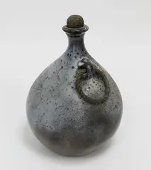 Lawrence Ewing, Stoneware bottle vase, ash glaze, original cork stopper and rope handle