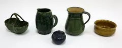 Luke Adams, Five assorted pieces, including two green glazed jugs, a basket, lidded sugar pot and a yellow glazed bowl